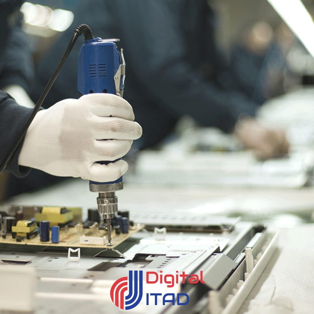 worker in gloves using an electric screwdriver to assemble an electronic circuit